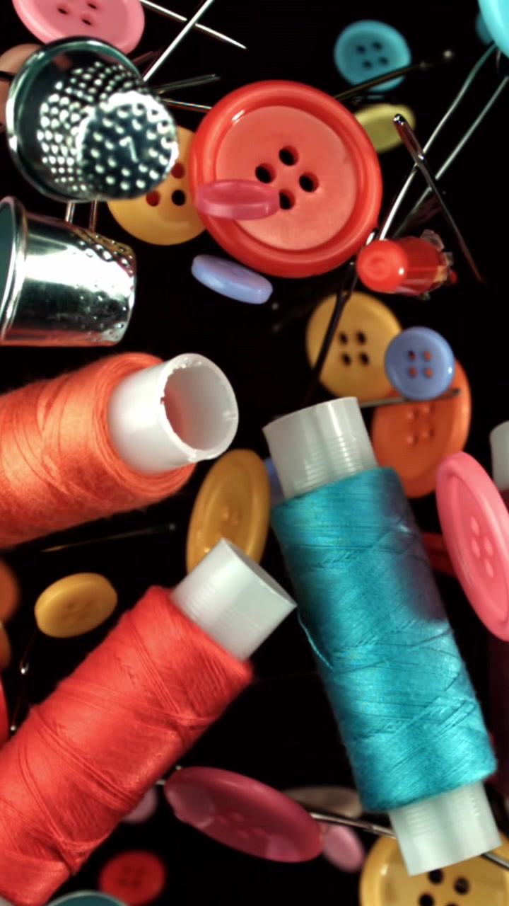 Close-Up of Vibrant Sewing Supplies on Black Background