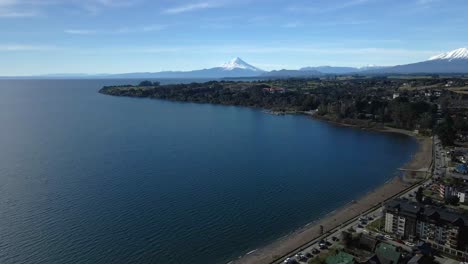 dolly out aerial view of lake llanquihue on the shores of the city of puerto varas, chile