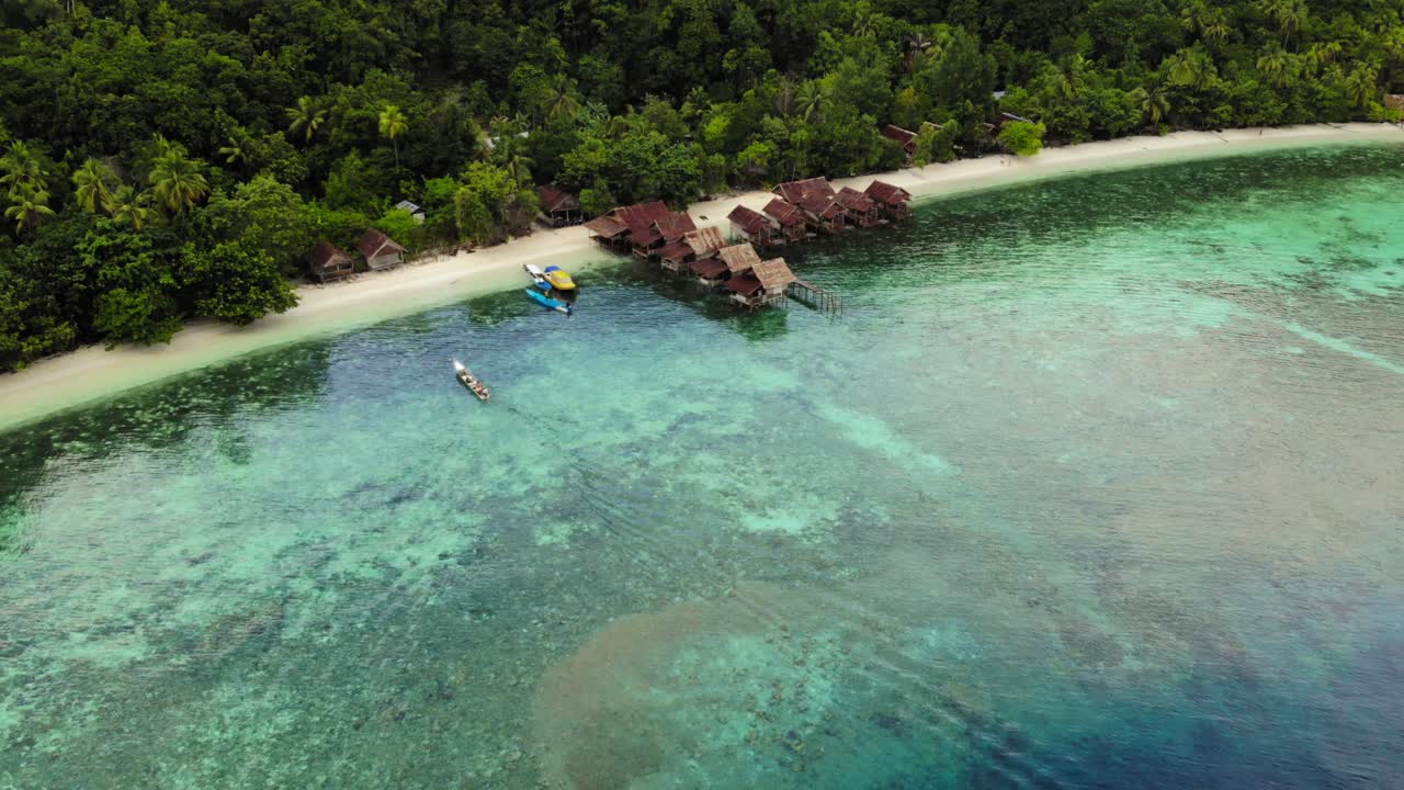 Aerial View of Tropical Island Resort with Overwater Bungalows and Clear Turquoise Water