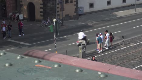 view from top of bridge of people waiting on a stop light on the streets of frankfrut in the summer