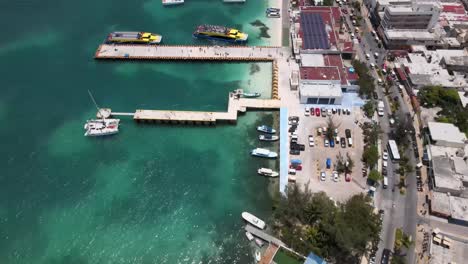 aerial footage of isle of mujhares main street and tourist boats docking