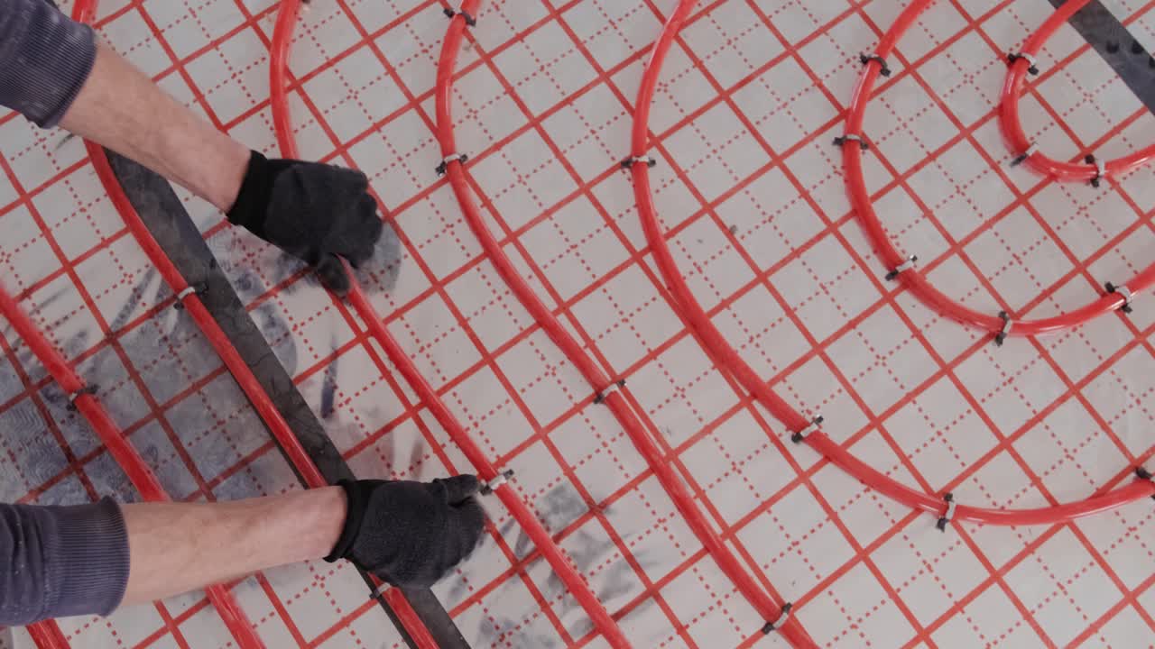 Installing underfloor heating pipes for water heating. Heating systems. Pipes for a heat-insulated floor.