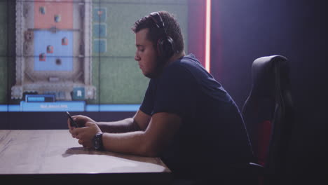 gamer playing mobile game in gaming room