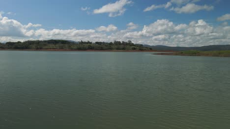 Low-Drone-Flyover-Water-Surface-Of-Arenal-Lagoon-Costa-Rica-On-Sunny-Day,-4K