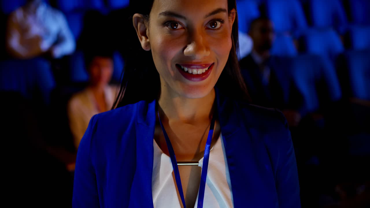 Donna d'affari che usa un tablet digitale a un seminario in auditorium 4k