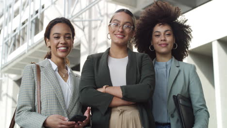 a diverse group of businesswomen standing outside