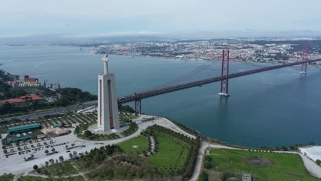 aerial wide drone view of lisbon bridge and sanctuary of christ the king - portugal