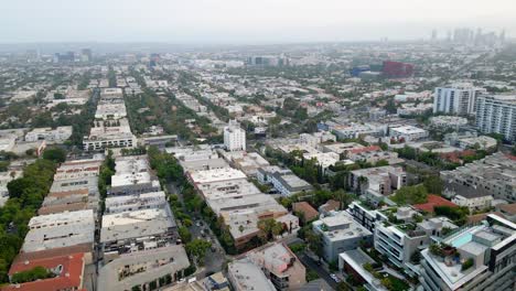 aerial view of the west hollywood cityscape, downtown los angeles in the background, in california, usa - pan, drone shot