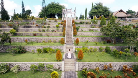 aerial riser view of female tourist ascending staircase at ujung floating palace