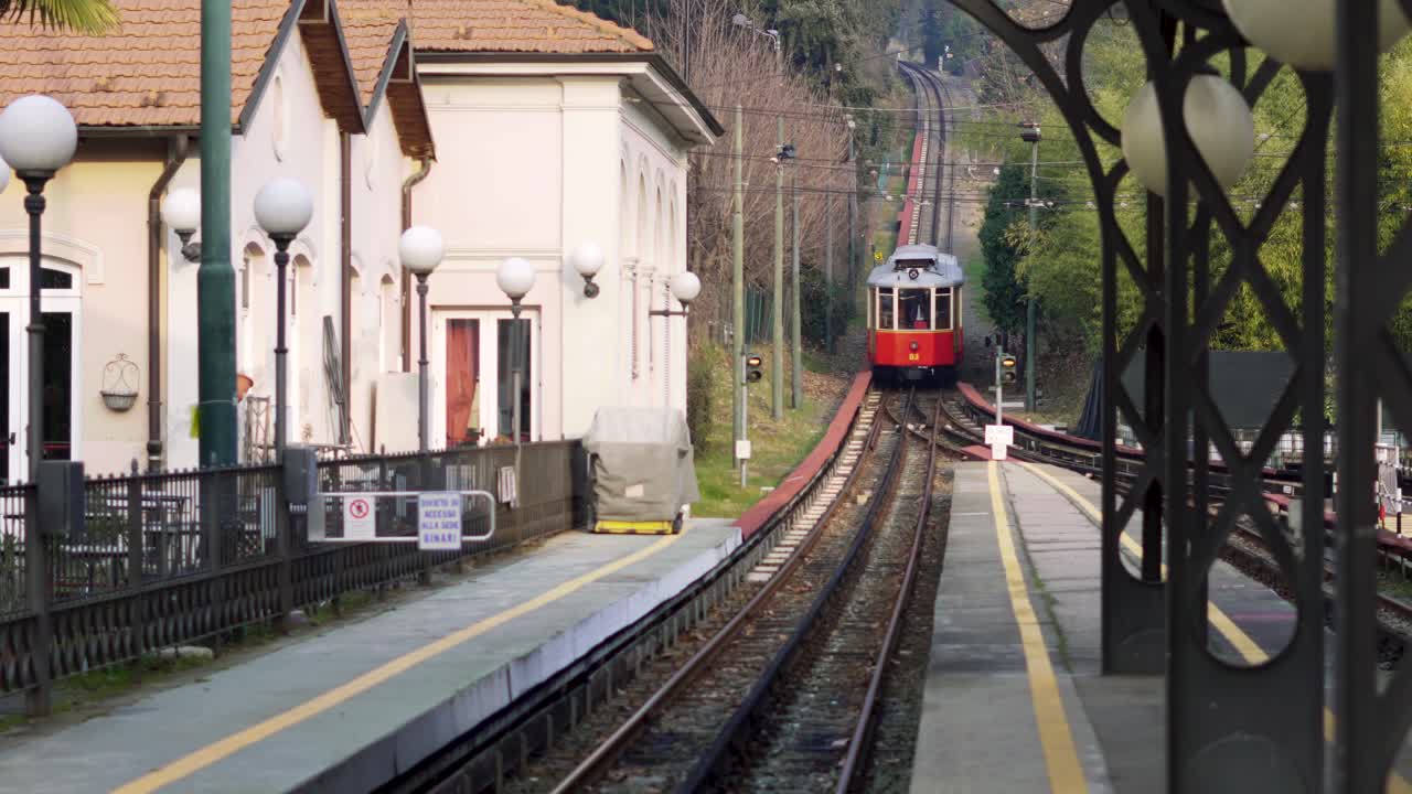 Red historic tram arriving at the station. Static