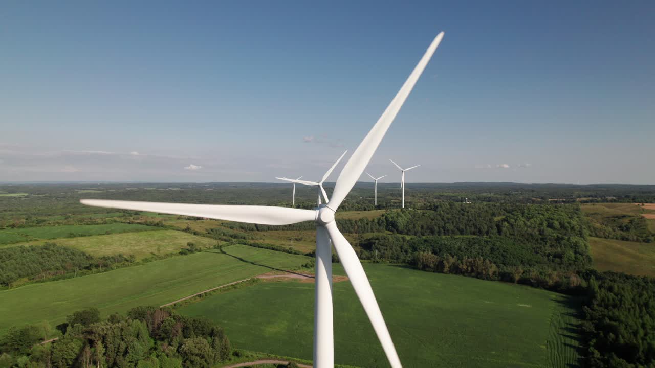 Wind farm in green nature surroundings, 4K aerial