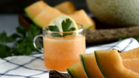 whole and sliced of japanese melons,honey melon or cantaloupe (cucumis melo) glass of melon smoothie healthcare concept.