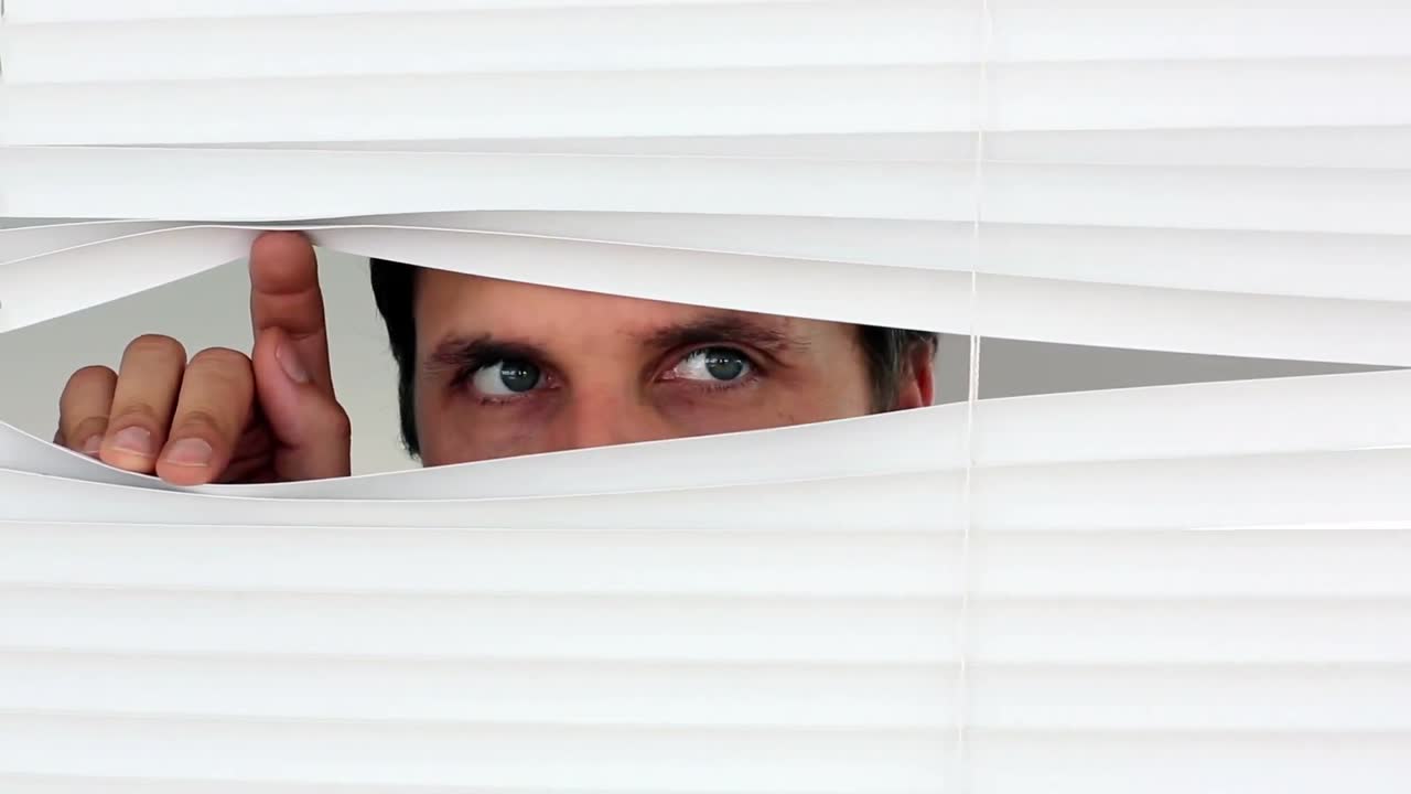 un severo hombre de negocios mirando por la ventana