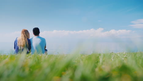 Multi-Ethnic-Couple-Resting-On-The-Green-Grass-Admiring-The-Beautiful-Nature