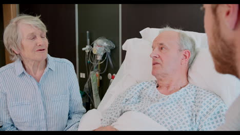 senior male patient and doctor talking in hospital room