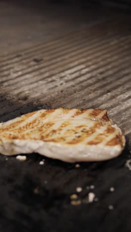 chef flipping the swordfish slice for grilling