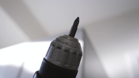 slow motion close up of a drill spinning in the air while building ikea furniture