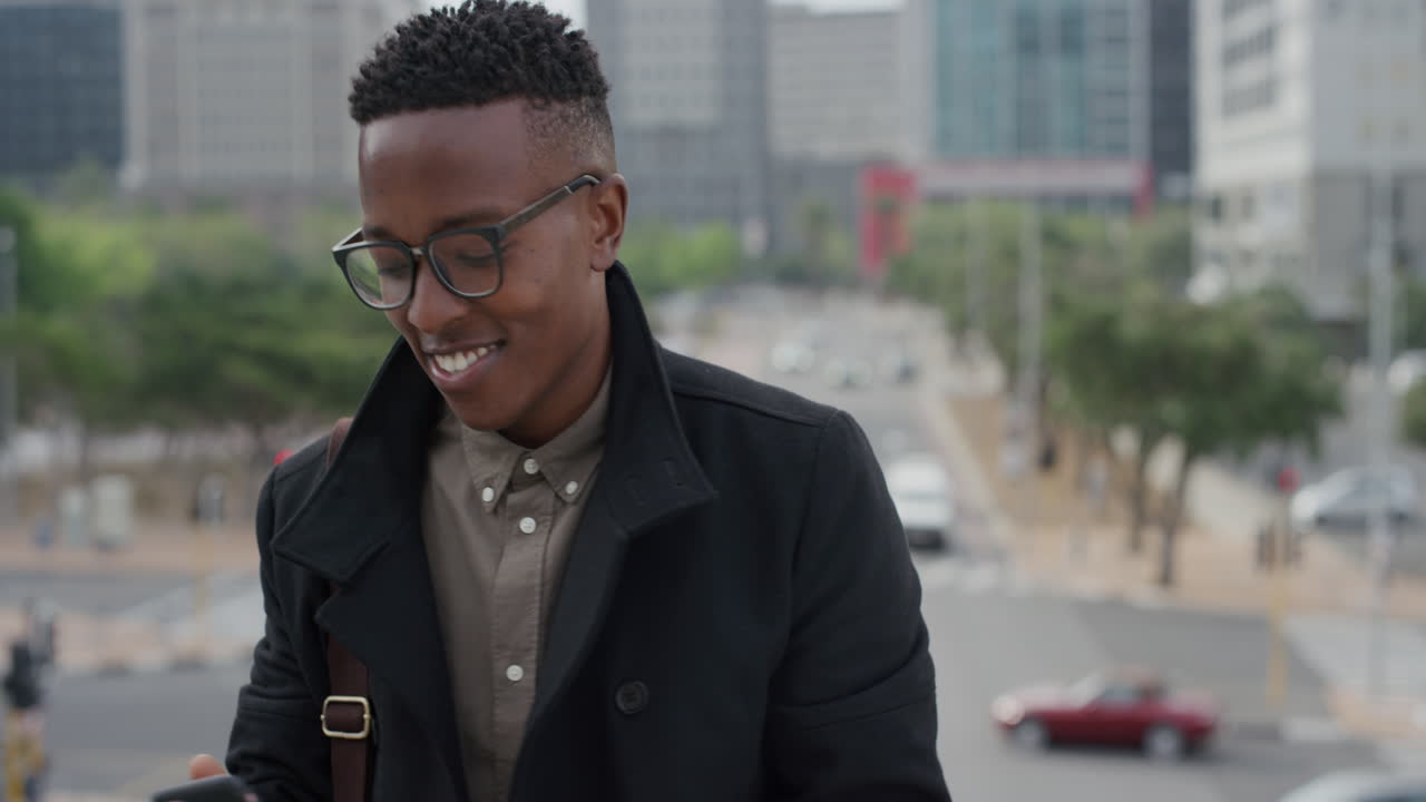 portrait happy african american man student using smartphone taking photos in city on mobile phone camera enjoying sharing travel experience trendy black male wearing glasses