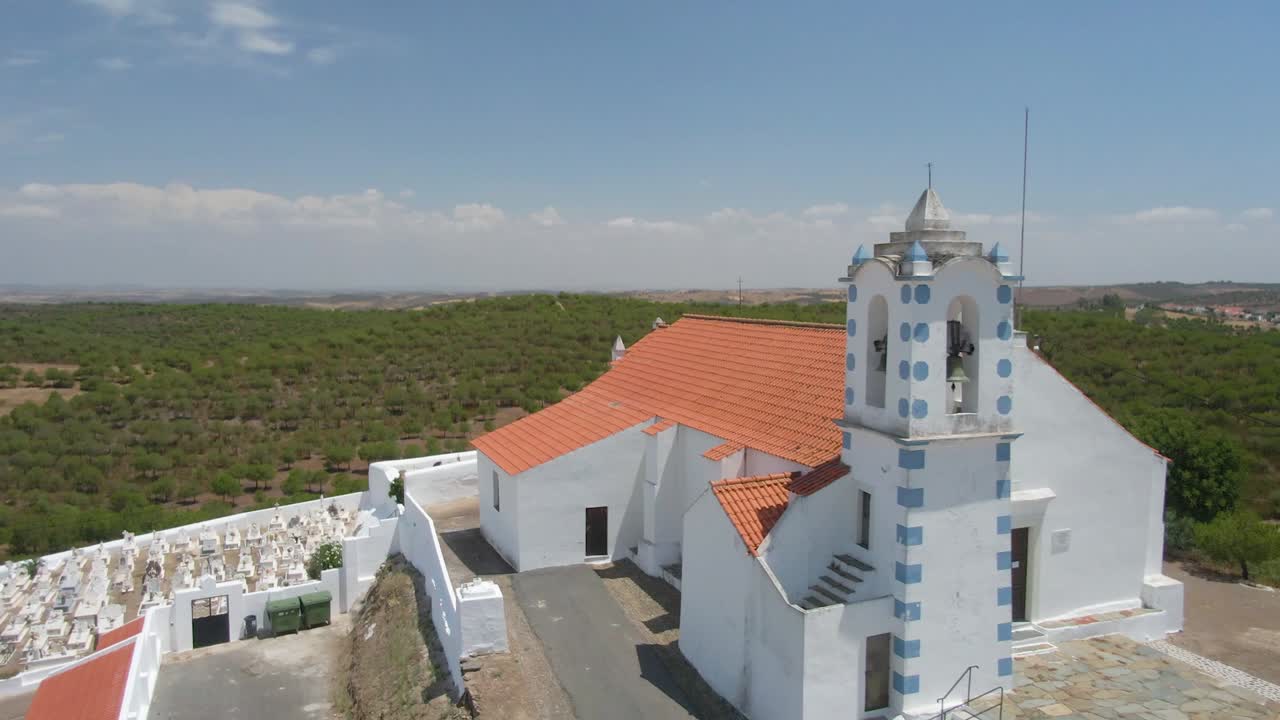 Drone shot of a small countryside church and its graveyard, in Alentejo, Portugal