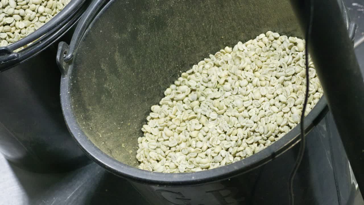 Witness the artistry of brewing fresh coffee grounds in a local roastery's cozy kitchen.