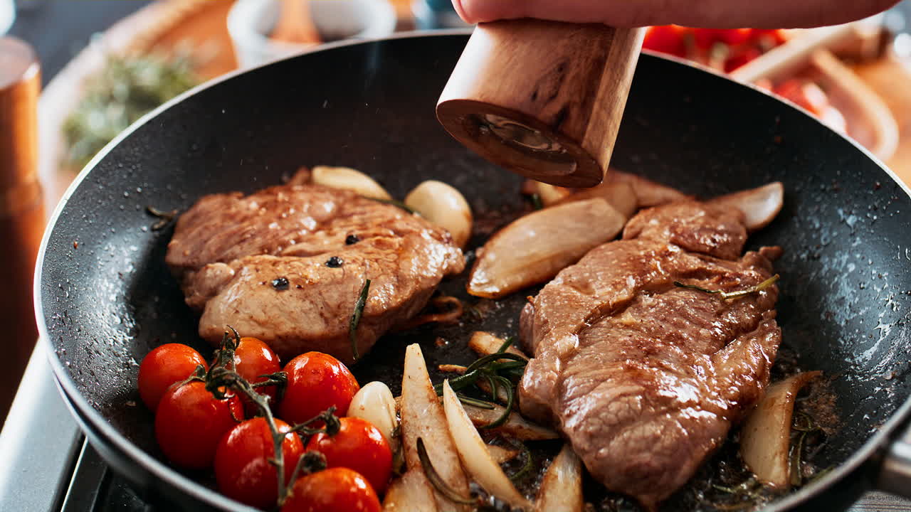 Steak cooking in pan