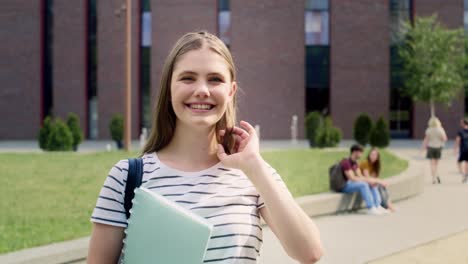 portrait of female university student standing outside the university campus