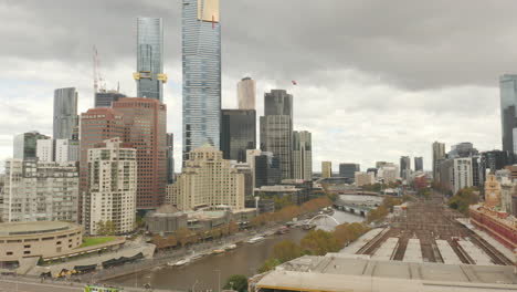 southbank as seen from fed square, melbourne, australia, with a red helicopter comes in to land at their river side access point