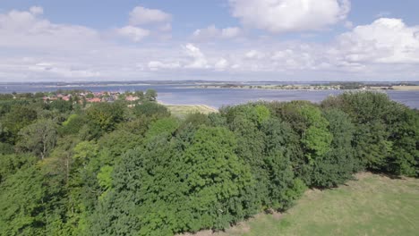 Aerial-Flyover-of-the-Countryside-with-a-Town-and-the-Sea---Dolly-Shot