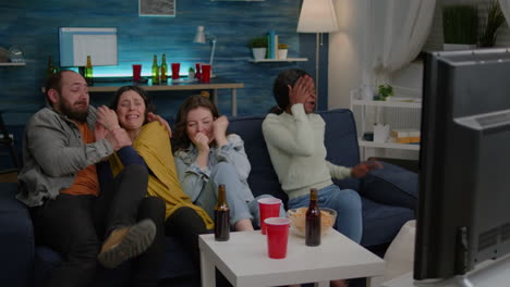 multi-racial friends screaming while watching thriller movie