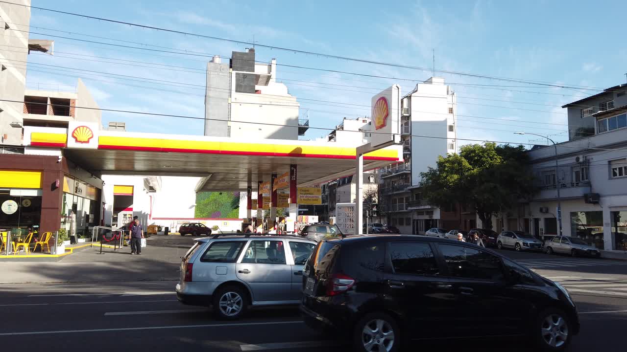 Establishing at Shell Petrol Station with traffic driving by Gaona Avenue flores neighborhood of Buenos Aires City at daylight, argentina