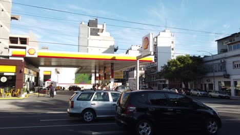 establishing at shell petrol station with traffic driving by gaona avenue flores neighborhood of buenos aires city at daylight, argentina