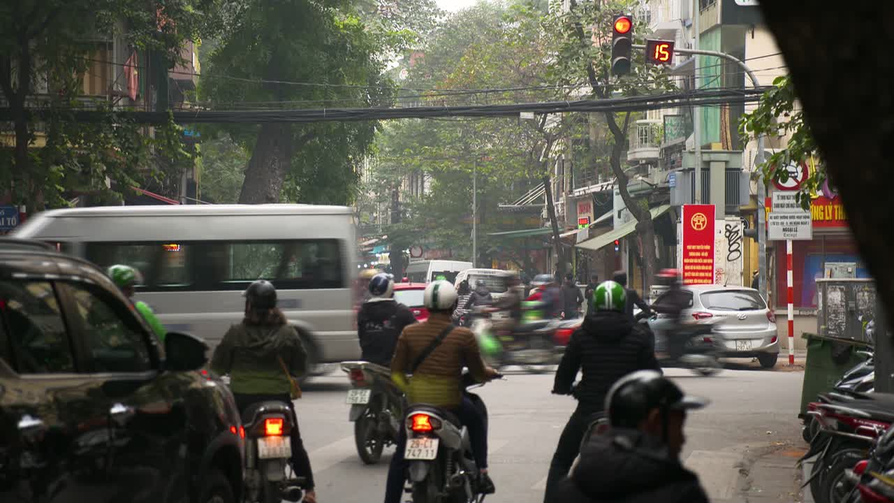 Transport Vehicles Traveling On The Street Around busy Intersection in Old Town Hanoi, Vietnam - Wide Shot