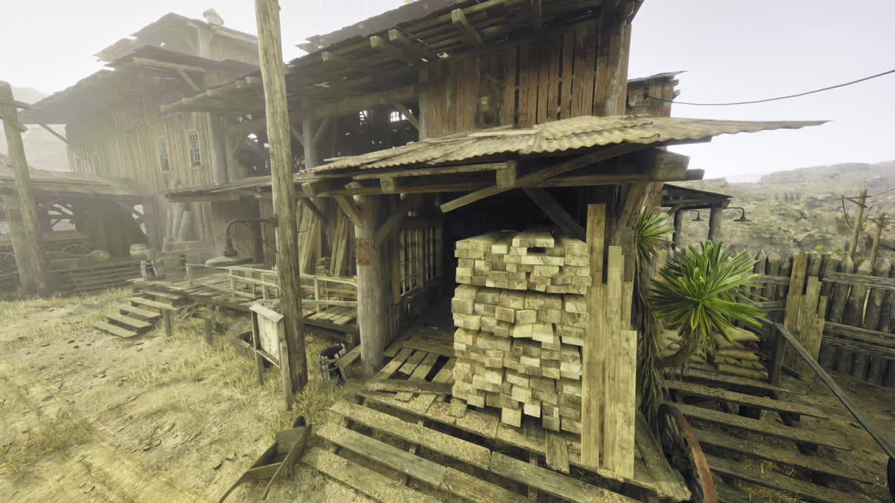 Old wooden structure with stacked lumber in a desert setting