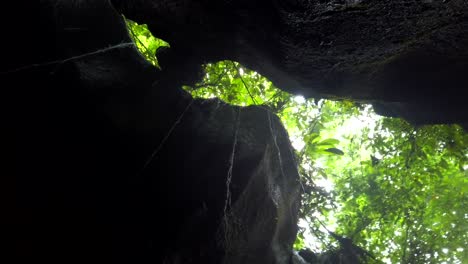 rotating-view-in-a-cave-with-a-waterfall,-Ubud,-Bali,-Indonesia