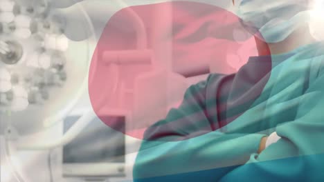 Animation-of-flag-of-japan-waving-over-surgeon-in-operating-theatre