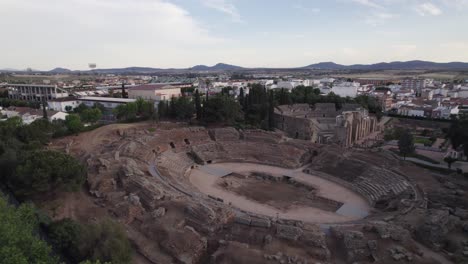 Aerial-ground-level:-Merida's-Amphitheatre-and-Roman-Theatre-Ruins,-Spain