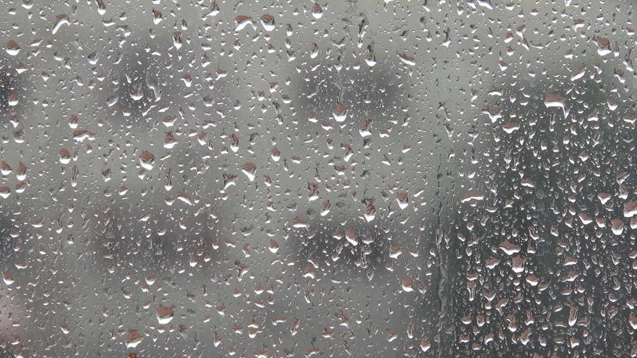 Rainy weather outside the window. Close up of a window with rain drops falling down