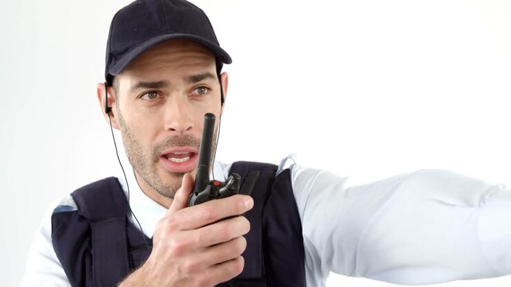 Security guard talking on walkie talkie