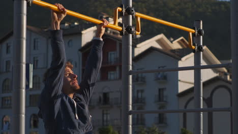 man doing pull-ups at outdoor gym