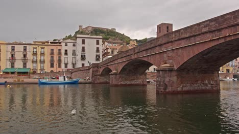 Beautiful-bridge-and-village-of-Bosa-in-Sardinia-island,-camera-motion-view