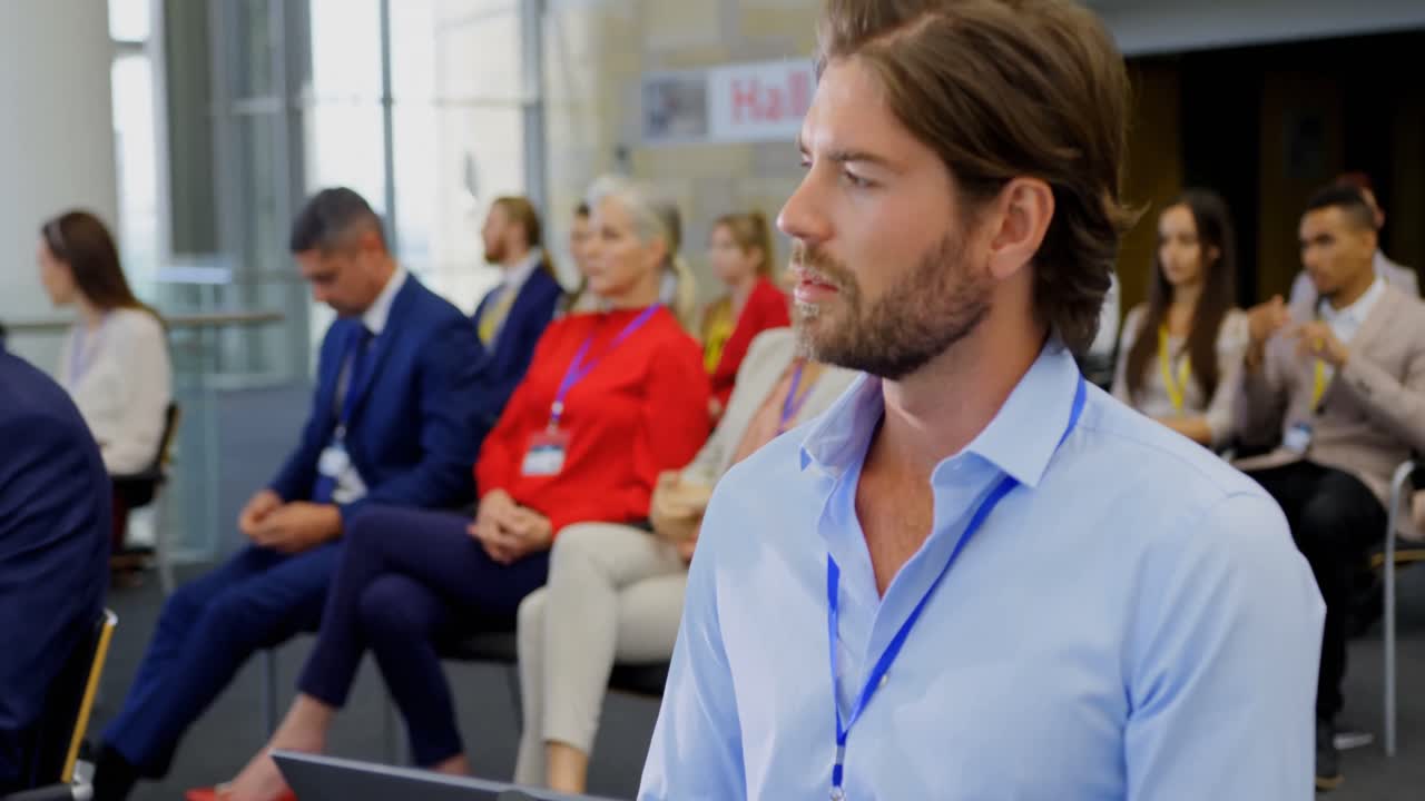Businessman sitting with laptop in the business seminar 4k