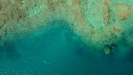 Aerial-right-tracking-shot-above-amazing-turquoise-water-and-coral-reefs-of-New-Caledonia