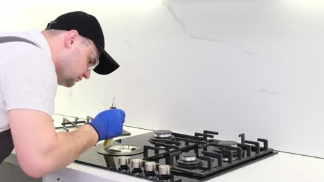 a qualified employee of the gas service installs a gas stove repair of the kitchen stove