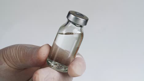 Medical Vial in a Gloved Hand