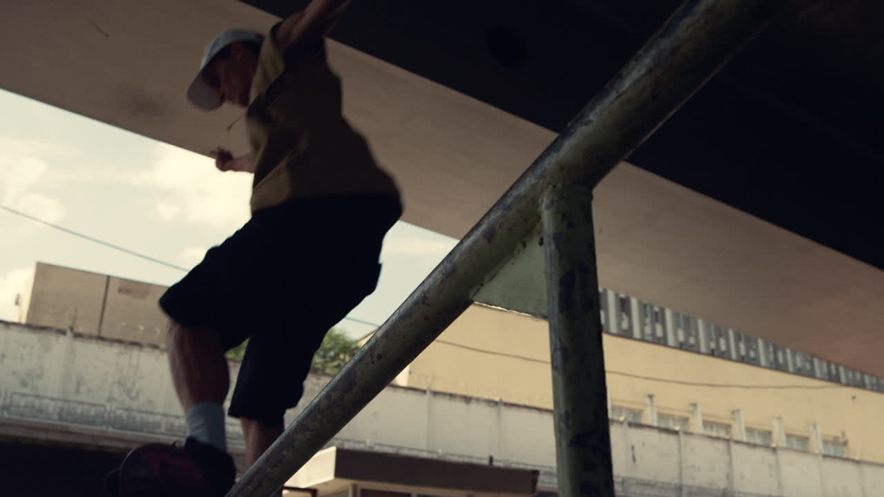 Young skater riding on skateboard at city skatepark. Boy performing skate tricks