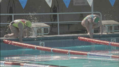 swimmers prepare to start a race