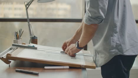 concept architectsengineer holding pen pointing equipment architects on the desk with a blueprint in the office vintage sunset light. close up of a draftsman drawing diagram on blueprints