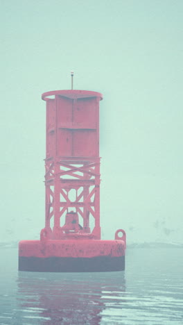 red buoy in foggy water