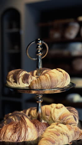 close up of croissants on a display in a bakery