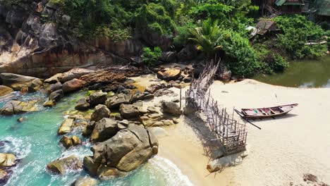 Haad-Than-Sadet-Beach,-old-wooden-pier-and-fishing-boats-on-the-sand